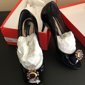 Black leather peep toe pumps by Claudia Ciuti